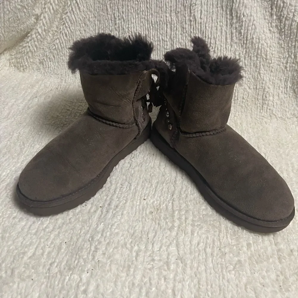 UGG Chocolate Shearling Boots with crystal and studs and bow accents SZ7